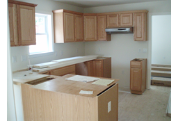 VIEW OF KITCHEN AS DELIVERED WITHOUT FACTORY COUNTERTOP, INCLUDES STANDARD FACTORY INSTALLED RANGE HOOD.